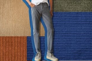 man from the waist down wearing grey corduroy pants, set against a background of a patchwork of different corduroy fabrics